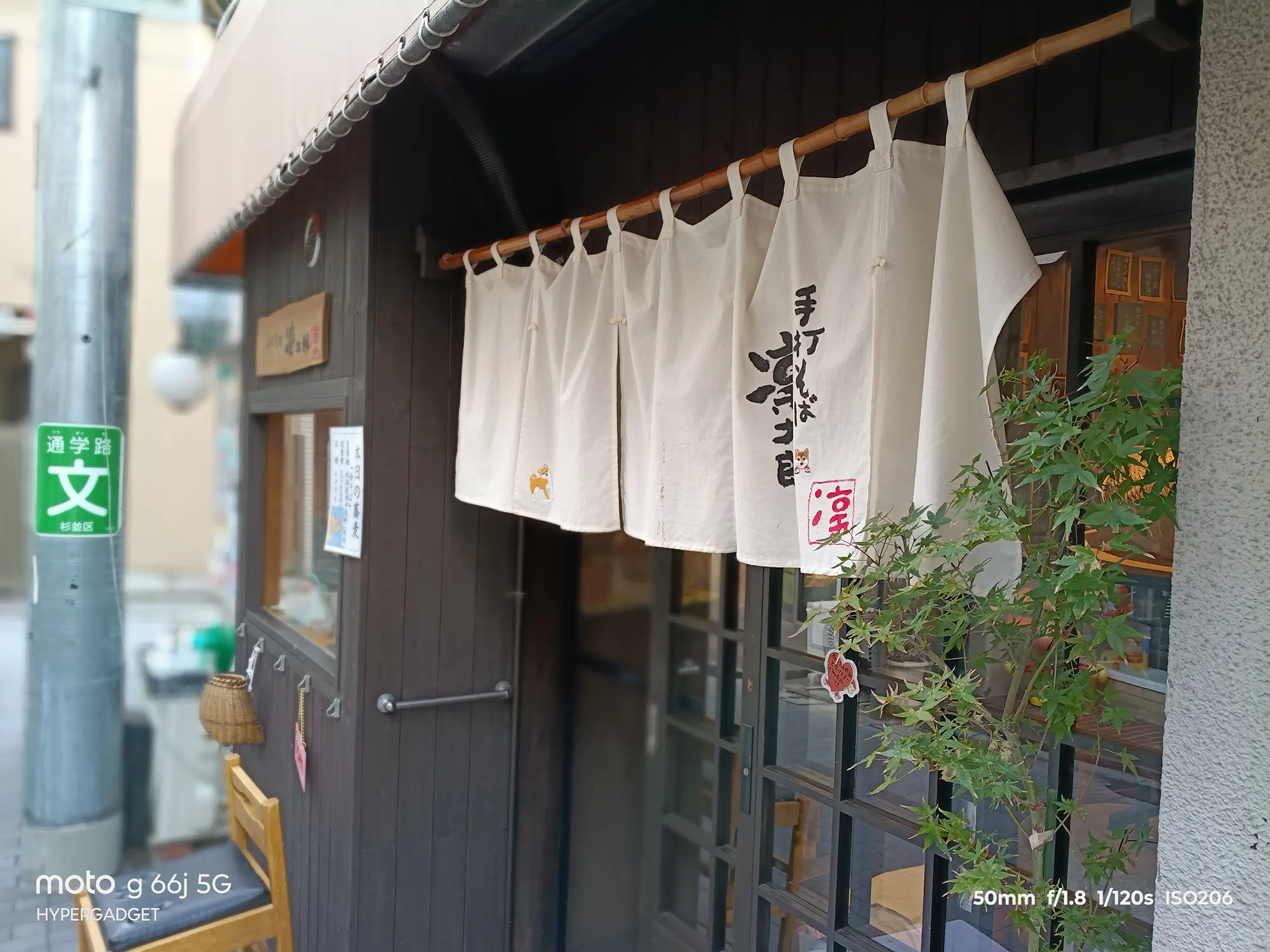 moto g66j 5Gのカメラ作例：和風店舗の白い暖簾を近接撮影。背景のボケ味と布の質感、手書き文字の描写をレビュー