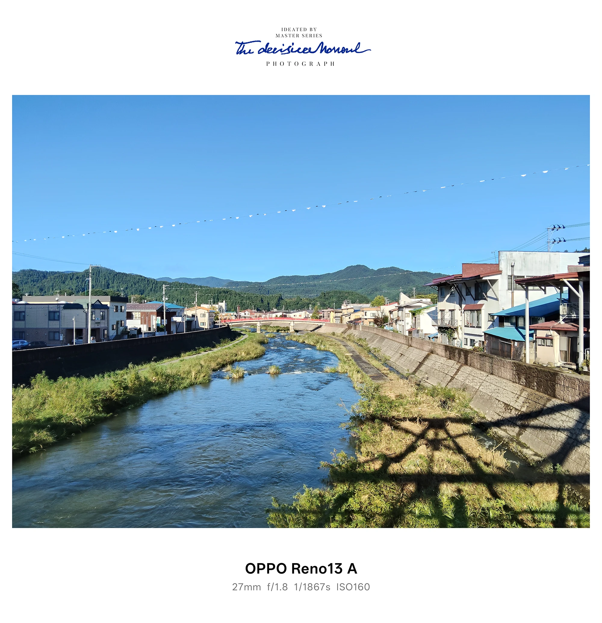 町中を流れる川と護岸、橋上からの遠景（OPPO Reno13 A）