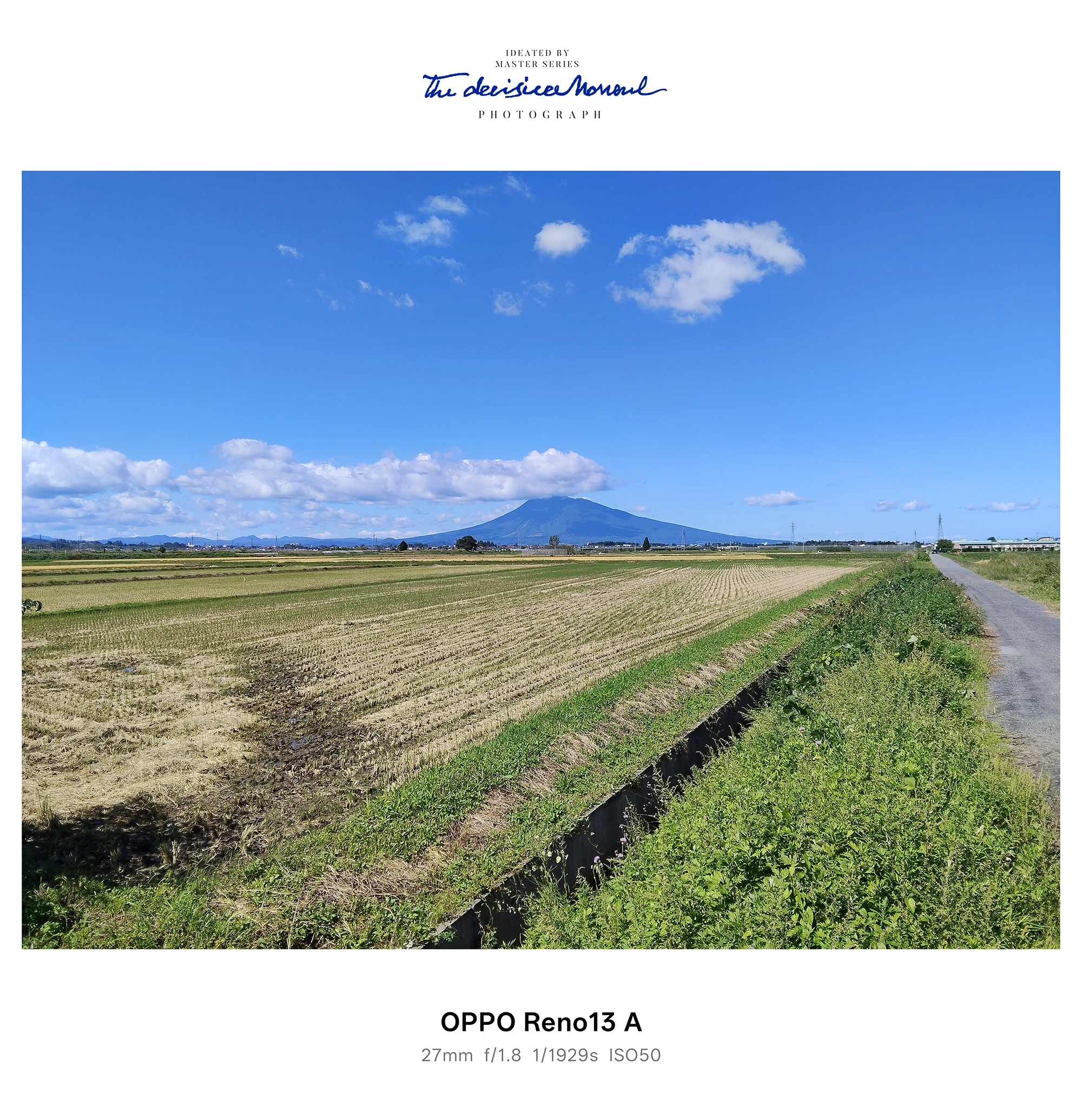 田園と畦道、遠くに山を望む快晴の風景（OPPO Reno13 A）