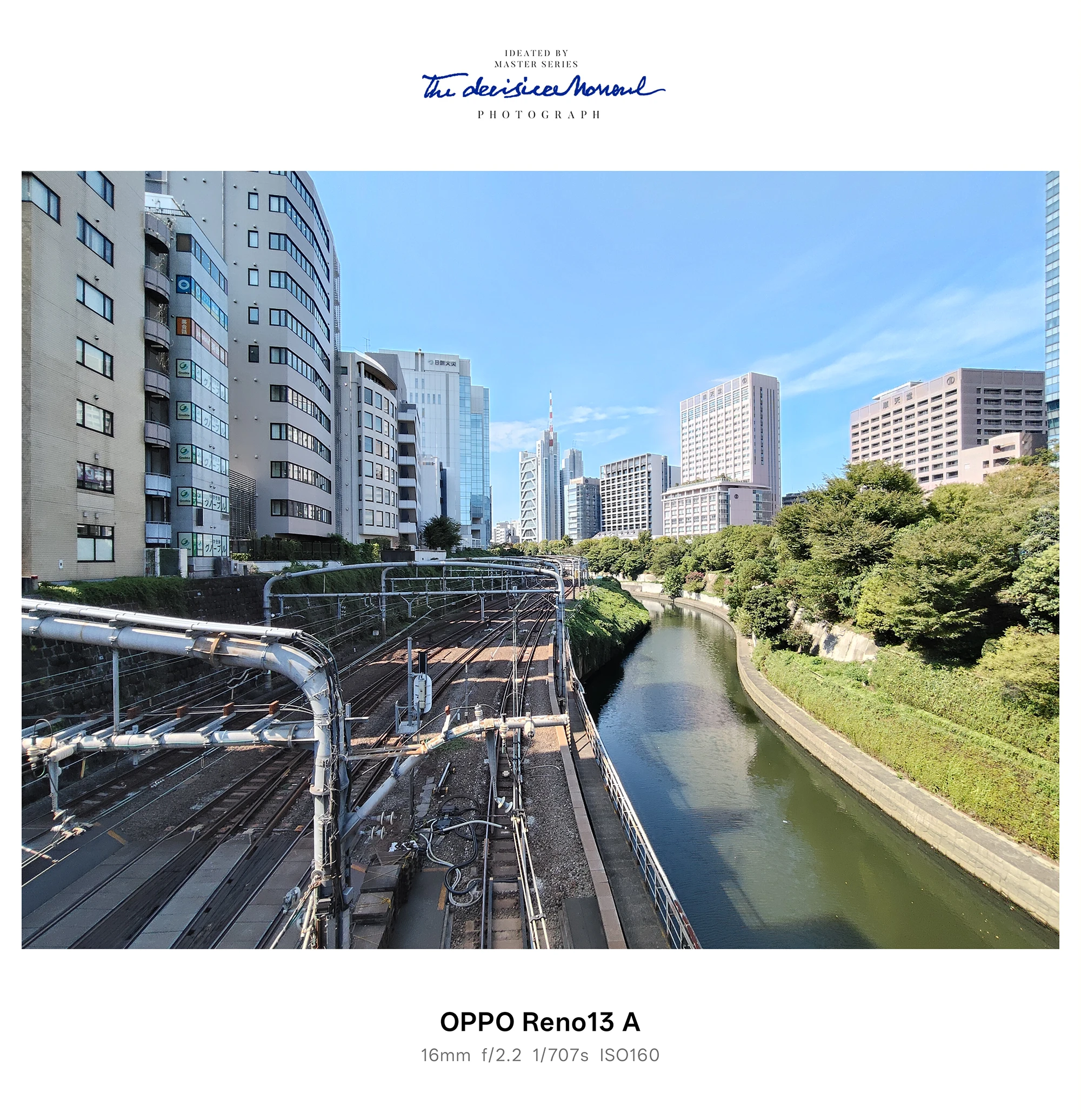 OPPO Reno13 Aの超広角で撮影した線路と運河、都市のビル群の遠景