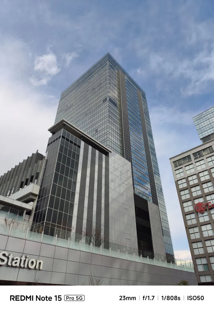 新宿駅前の高層ビルを見上げる広角ショット。Redmi Note 15 Pro 5G(23mm)で撮影。